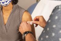 A patient receives a booster shot.